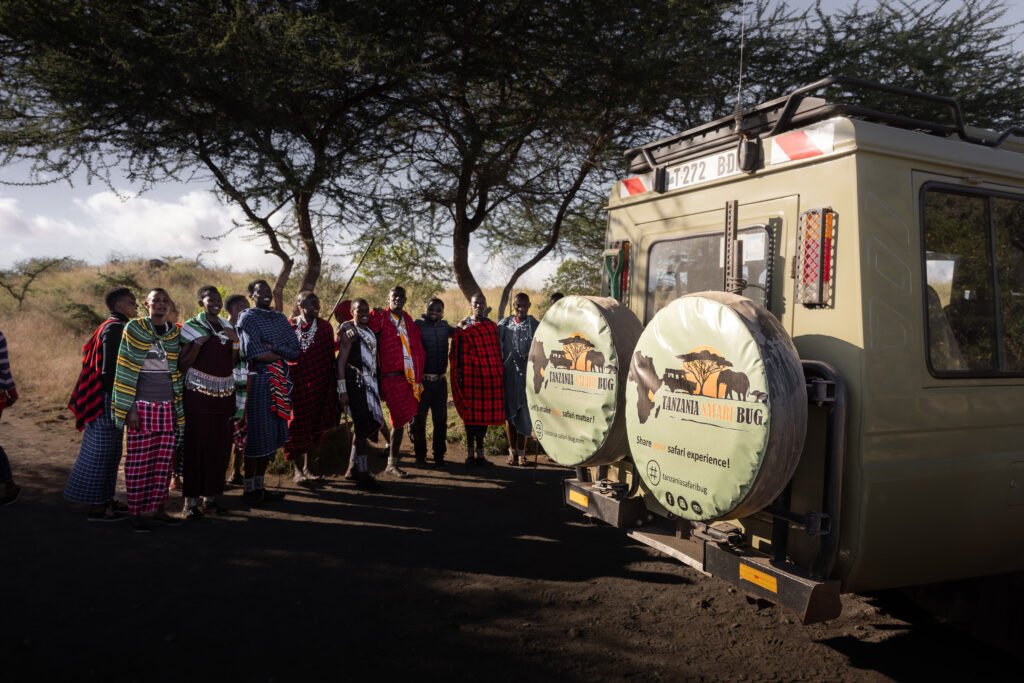 The local Maasai community in Tanzania greeting the Tanzania Safari Bug vehicle.