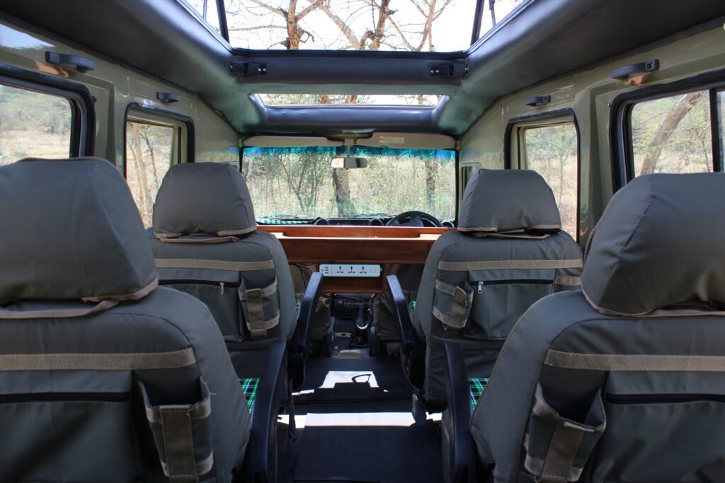 Tanzania Safari Bug vehicle interior with comfortable chairs and perfect game viewing options.