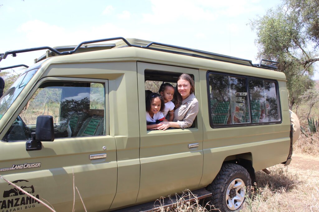 Sandra and kids in the Tanzania Safari Bug vehicle.